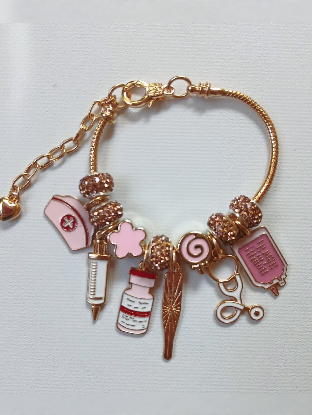 Gold-Tone Charm Bracelet with Pink Accents